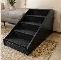 Black upholstered four-step pet stairs in a lounge